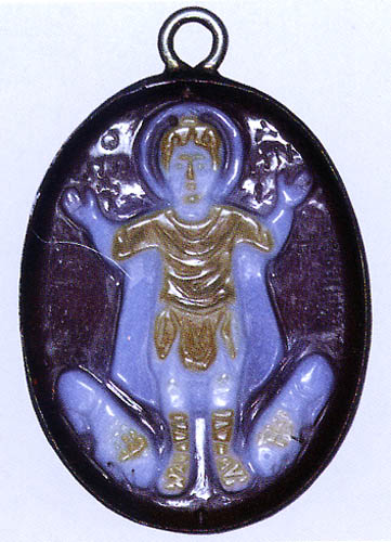A sardonyx cameo carved with a haloed man raising his arms in between two lions at his feet.