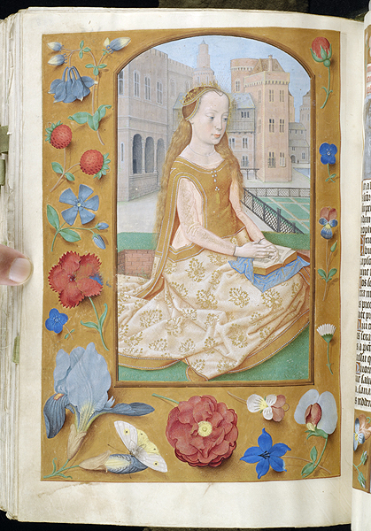 A decorated manuscript page depicting a woman with long blond hair, with rays around her head, wearing a crown and long dress , kneeling with an open book on her lap. The borders of the manuscript painted with strewn buds of flowers, strawberry, and moth against a gold background.