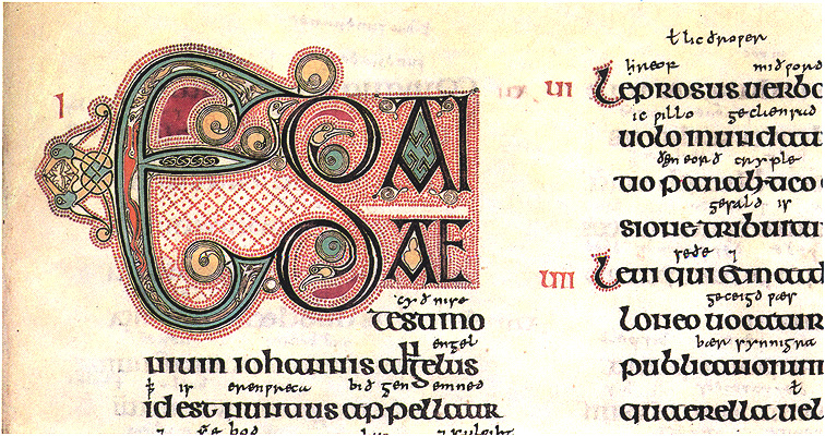 A detail of a manuscript page that contains an ornamented initial in multiple colors beside Latin text.