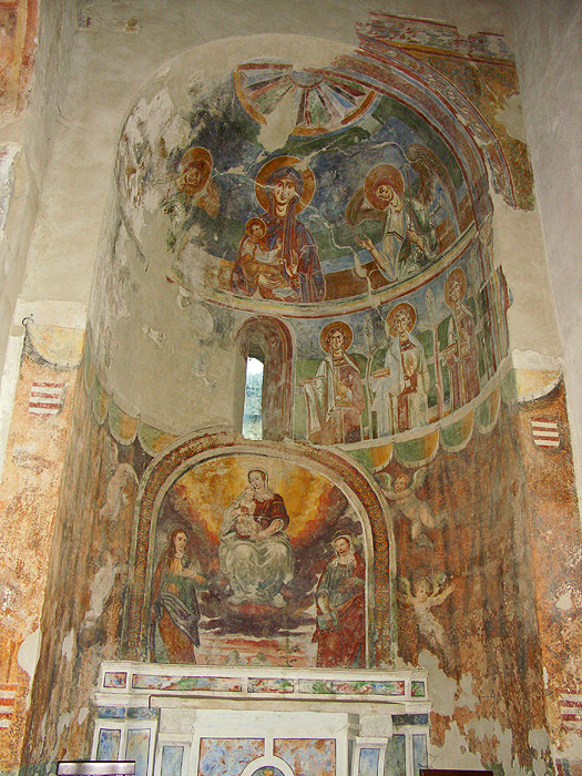 General view of apse with many figures painted in fresco, located at the east end of a church.
