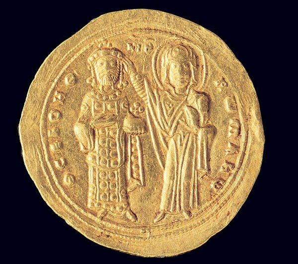 On the reverse of a gold coin, a woman with a halo touches the head of a man wearing a crown. They are surrounded by an inscription.