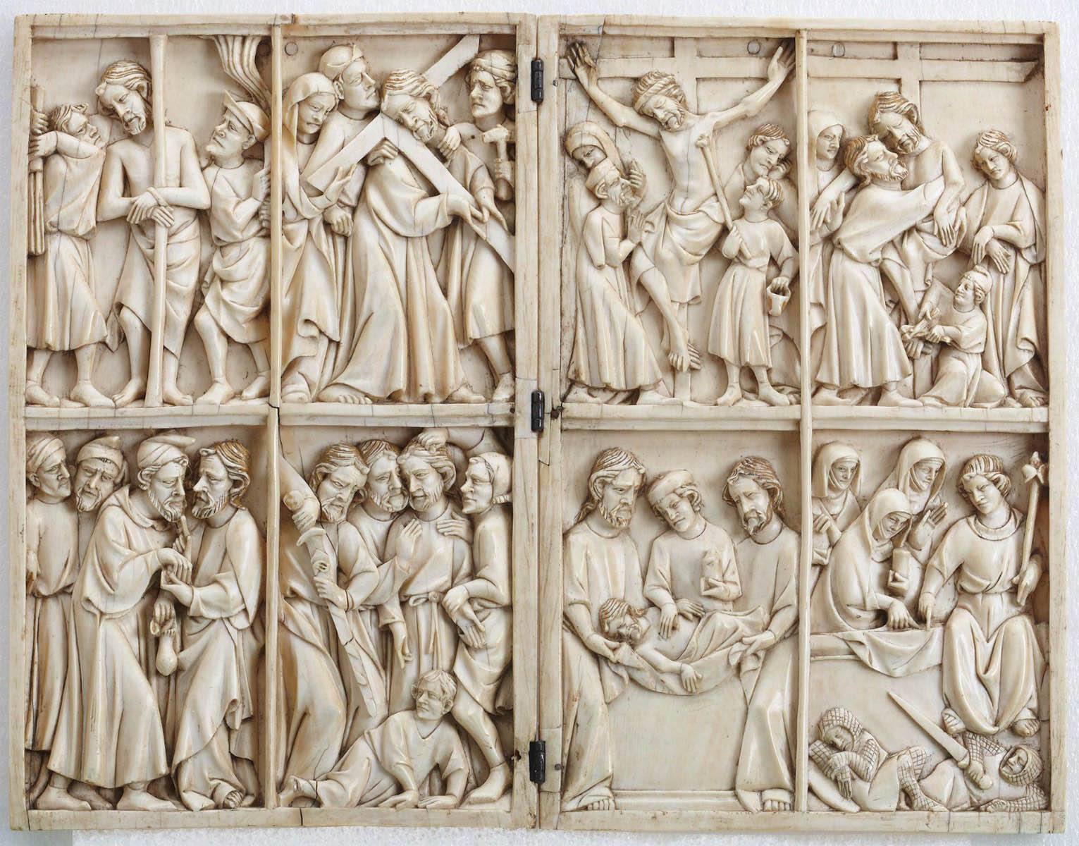 On a carved ivory diptych, several scenes with multiple figures.