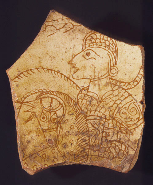 On a sherd of pottery, a figure in armor and on horseback and possibly holding a shield on horseback.