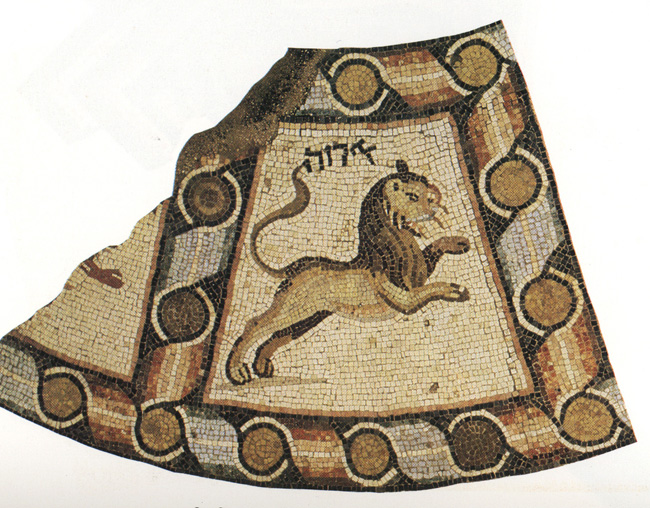 Detail of mosaic pavement depicting leaping lion, symbolizing the Zodiac Sign of Leo, and possibly part of crab, which symbolizes Cancer (fragmentary), inscribed with Hebrew letters and surrounded by ribboned border of alternating red and blue tiles.