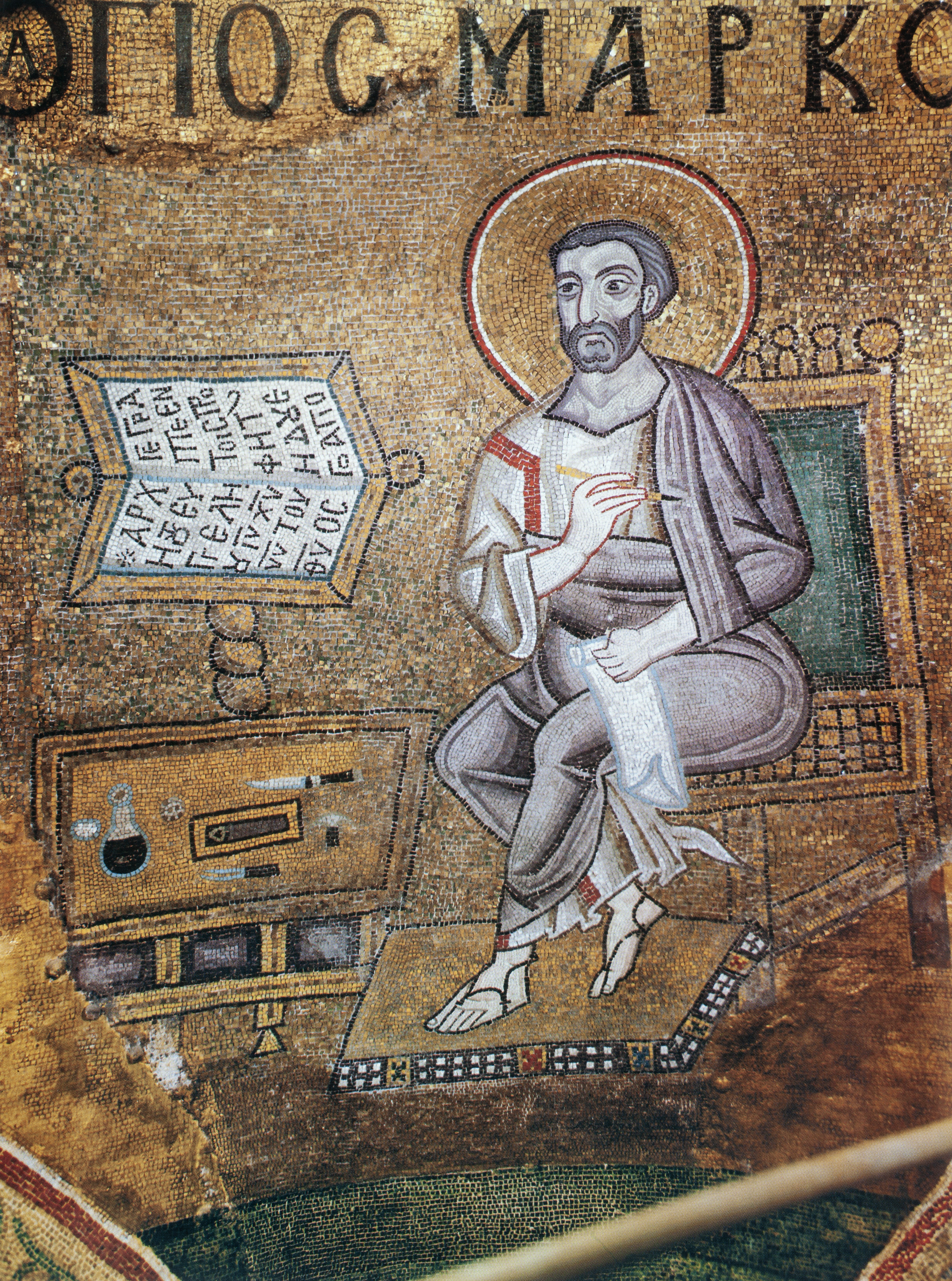 Mosaic of male figure seated at table with writing implements