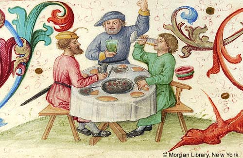 Detail of a manuscript illumination depicting three men wearing hats, eating and drinking at a round table with dishes of food, among colorful vines.