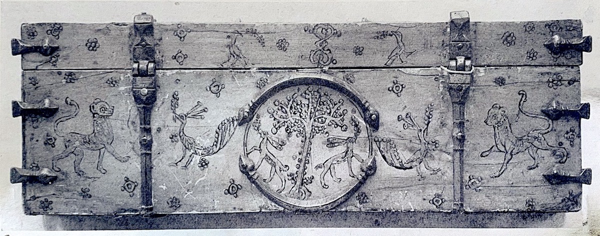 Painted back of rectangular ivory casket depicting tree and rabbits in central medallion, pairs of peacocks and lions. Metal fittings and braces.