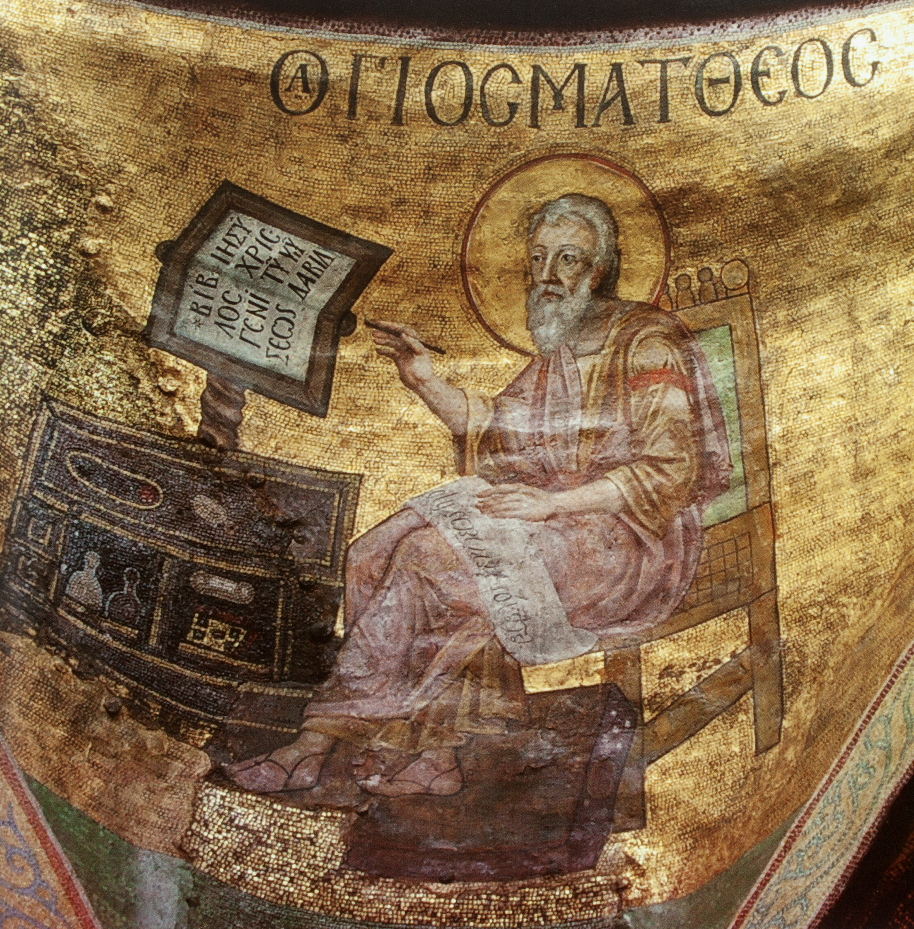 Mosaic of male figure seated at table with writing implements