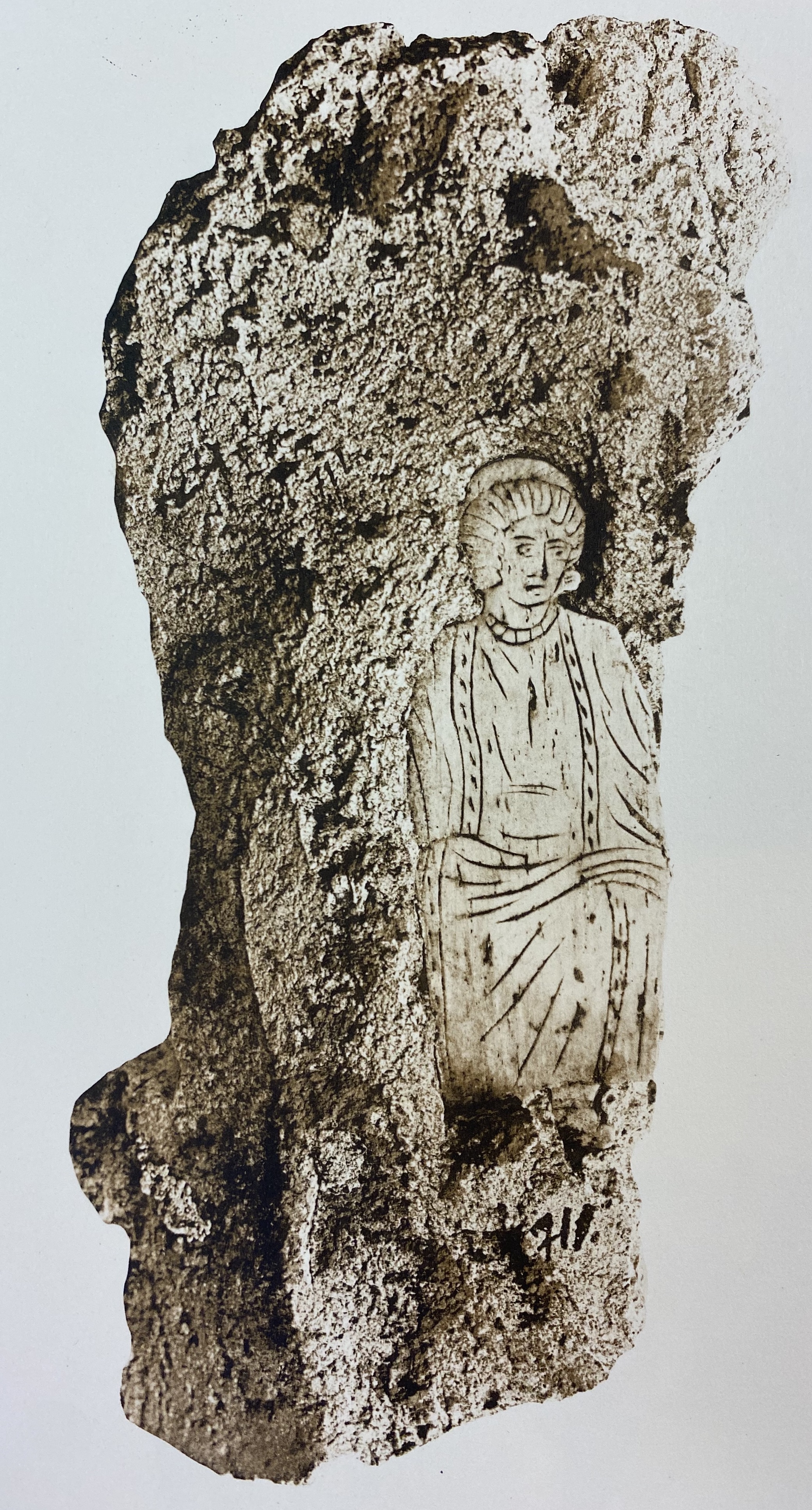 Bone plaque representing female figure set in mortar.