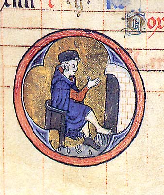 A manuscript illumination with a roundel containing a man seated before a fireplace, one shoe removed to warm his foot.