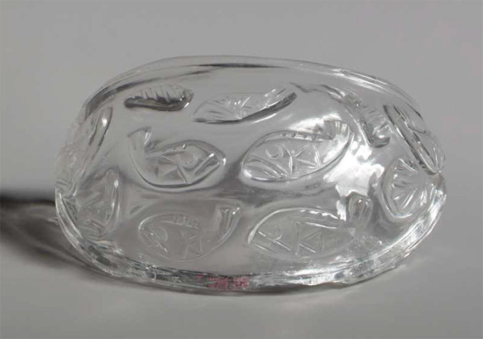 Crystal bowl shaped like ship and decorated with fish and foliage. 