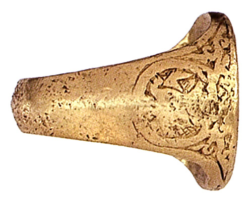 The decorated hoop of a gold ring.