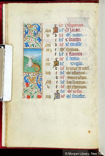 A manuscript page with calendrical text to the right of a narrow field with foliate decoration and a hybrid animal with the foreparts of a goat and the tail of a fish.