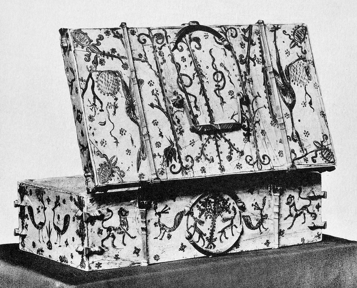 Painted casket with its lid open, seen from the back and side. It is made of painted ivory, with metal fittings and braces.