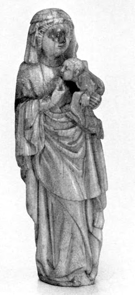 An ivory statuette of a standing woman holding an infant.