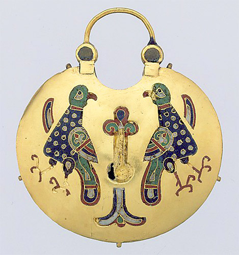 A circular gold pendant with enamel images of a tree of life flanked by two birds.