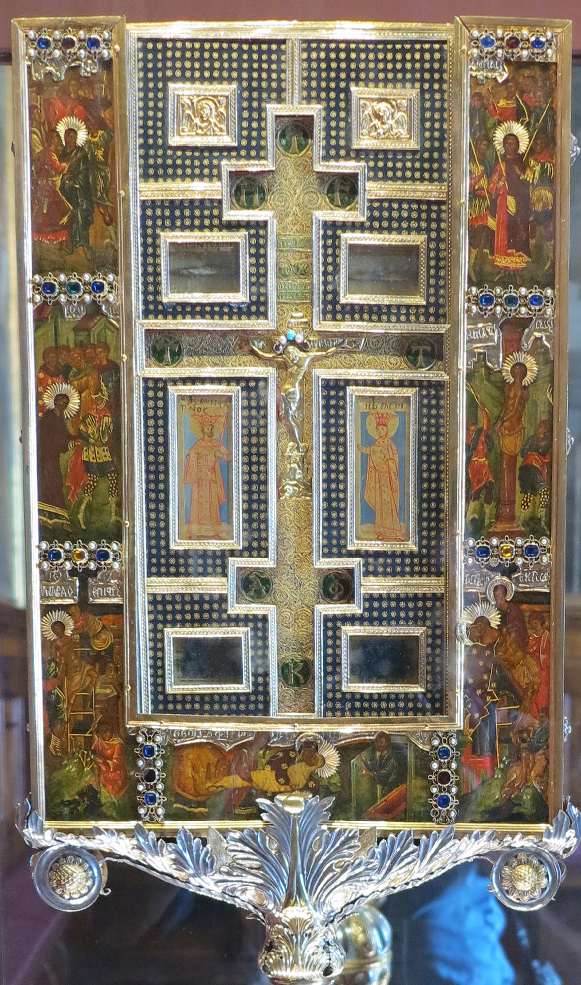 A painted reliquary with a metalwork cross.