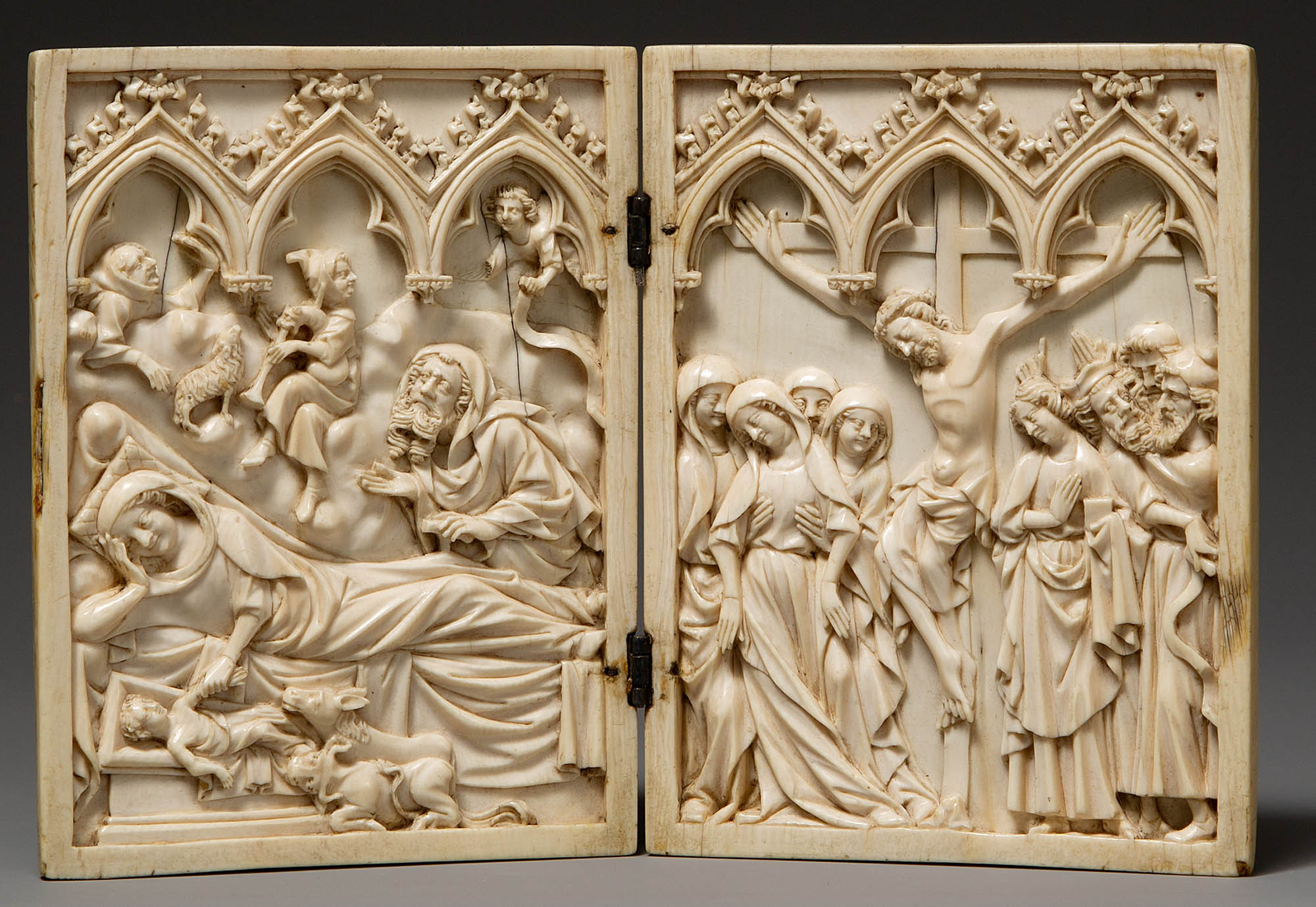 On a carved ivory diptych, several figures, including a reclining woman and a man on a cross.