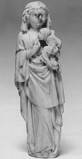 An ivory statuette of a standing woman holding an infant.