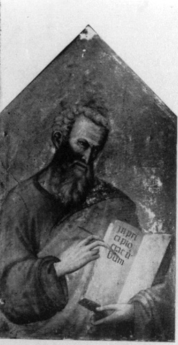 A black and white photograph of a panel painting of a bearded man with a halo, who is writing letters on an open book.