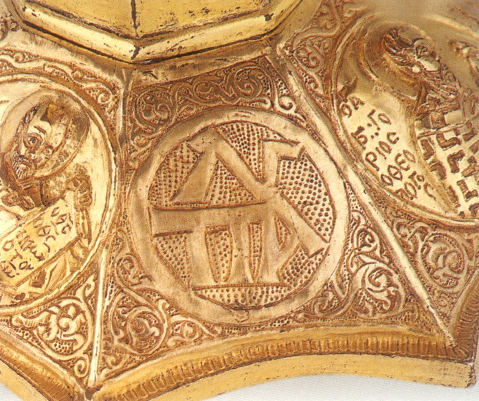 Chalice with monogram in Greek in the center and male figure in medallion on the right.
