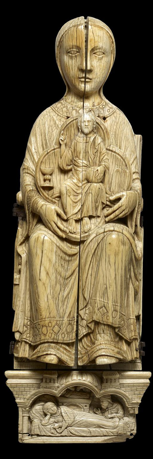 An ivory sculpture of a seated woman.