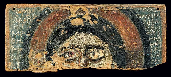 Upper half of head of male figure flanked by inscription in Greek.