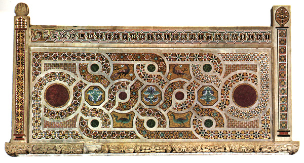 A marble panel containing a mosaic of interlace ornament in multiple colors.
